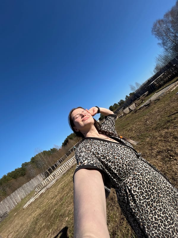 Woman takes selfie outdoors in Rusalevka on sunny afternoon