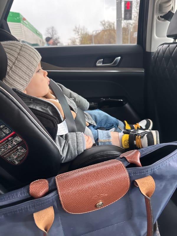 Child rests in car seat during Moscow travel