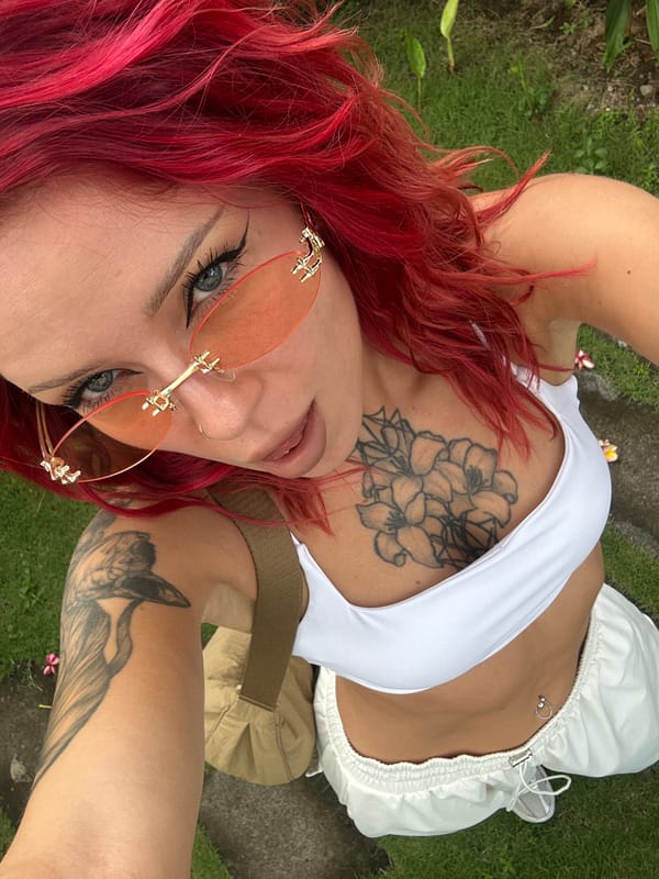 Red-haired woman photographed in white outfit in North Kuta