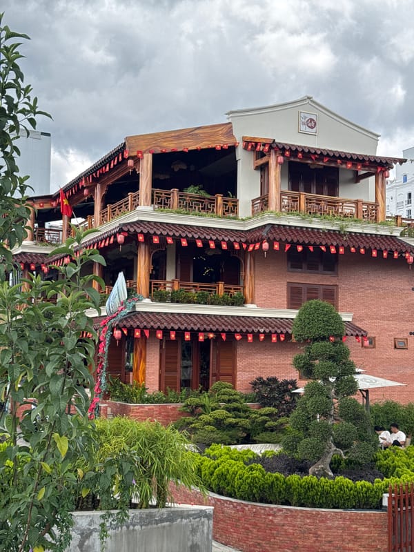 Traditional Vietnamese building with flags observed in Da Lat