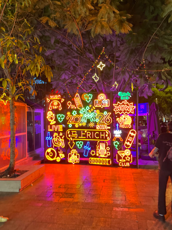Neon-lit commercial streets of Liangjiang on a summer night