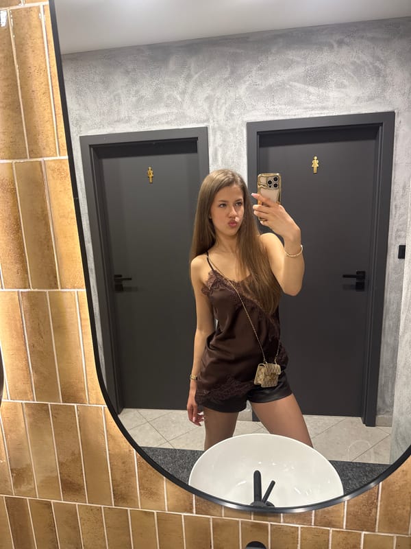 Woman takes mirror selfie in Ruse restroom