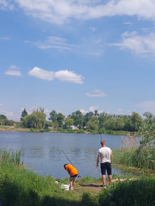 Sunny fishing morning at Bobrivnyk lake draws peaceful observers
