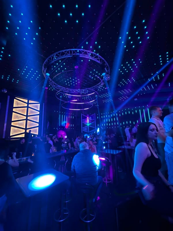 Nightclub scene with patrons and colorful lighting in Gabrovo