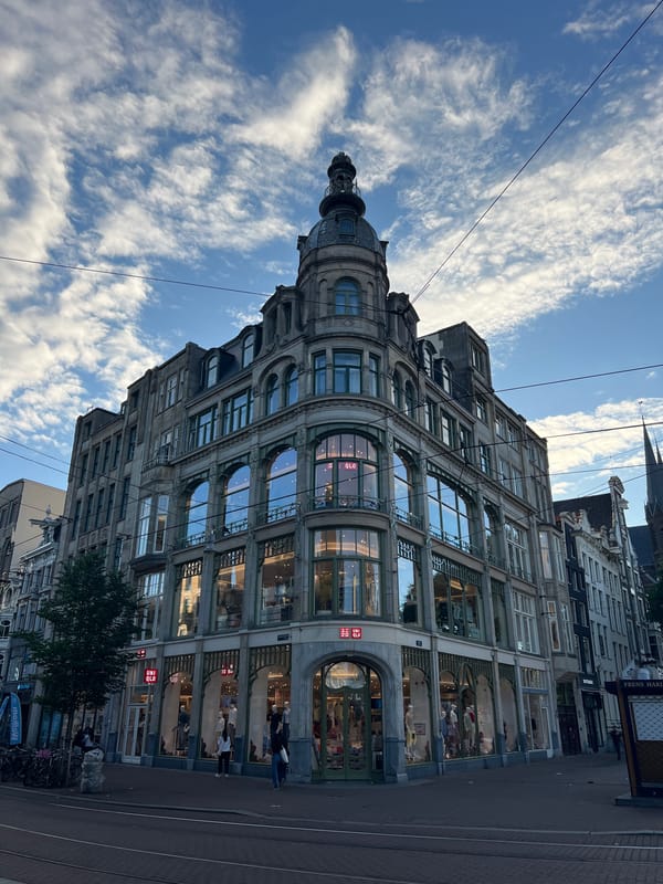 Amsterdam canals and corner architecture on a June evening