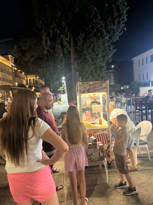 Coastal evening: waterfront dining, old stone walls, and city streets