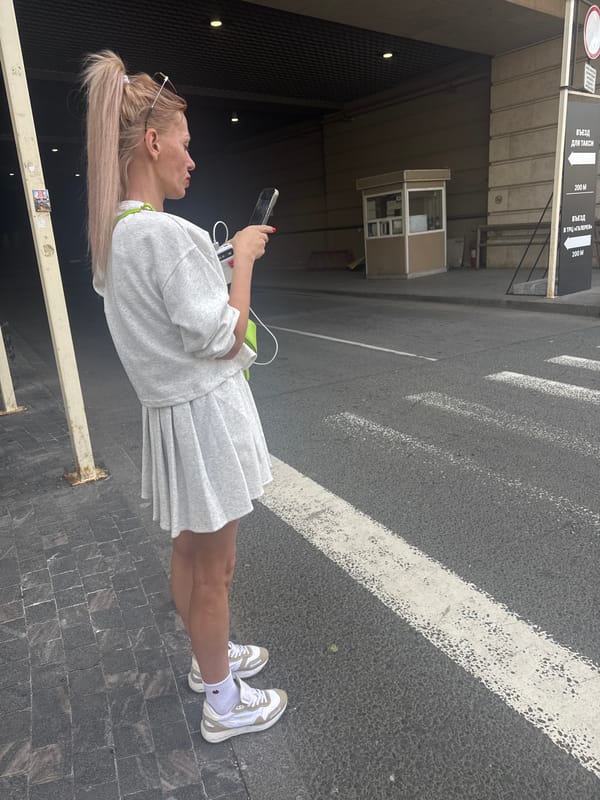 Woman takes selfies during morning walk through Saint Petersburg