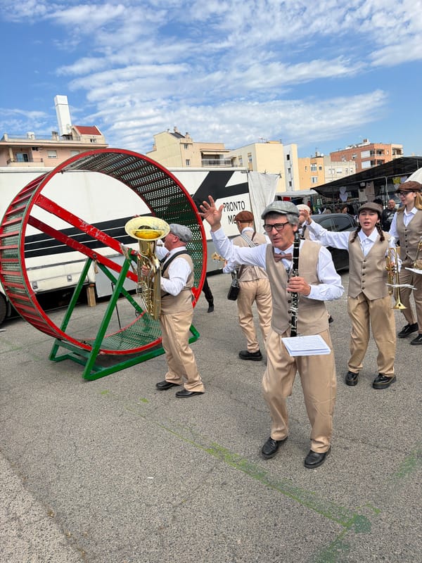 Street performers with brass band, hamster wheel entertain Spanish towns