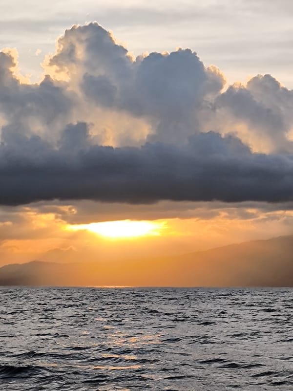 Boat journey documented off Indonesian coast during sunset