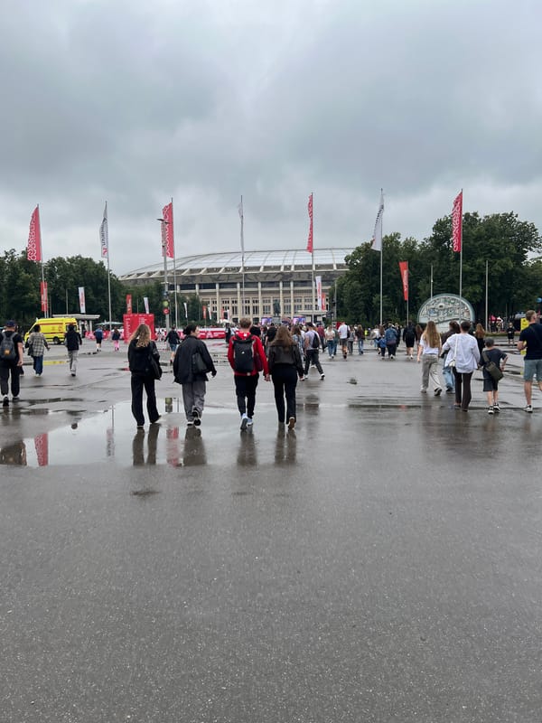 Crowds outside Luzhniki Stadium on a wet Moscow day