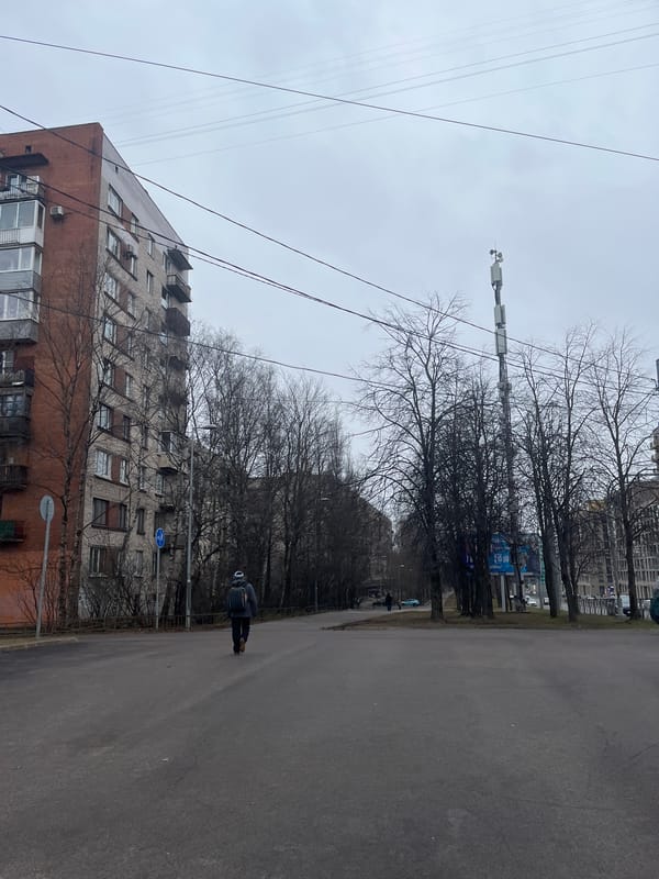 Pedestrian documents overcast street scene in Saint Petersburg