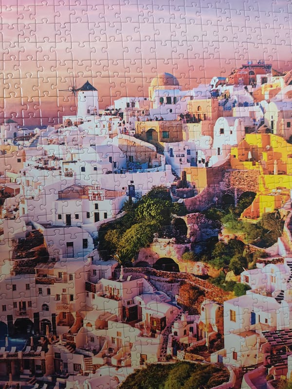 Person works on European village jigsaw puzzles