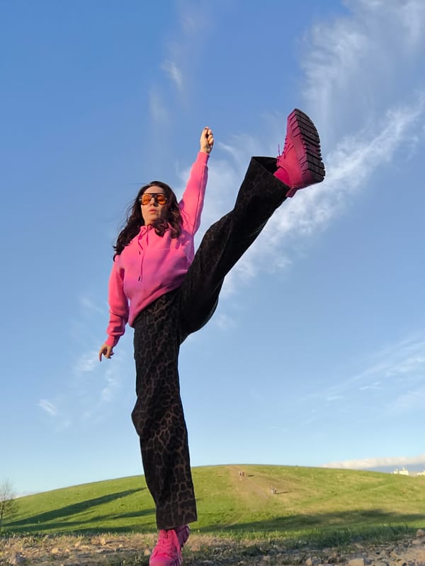 Woman poses in bright outfit during outdoor photoshoot in Riga