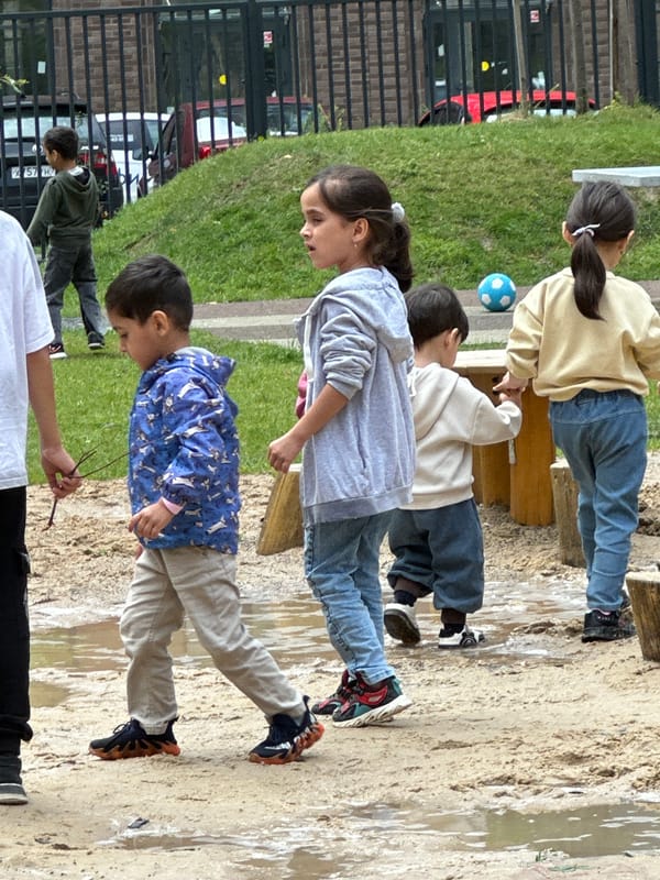 Kids at play in a Russian neighborhood playground on a summer morning