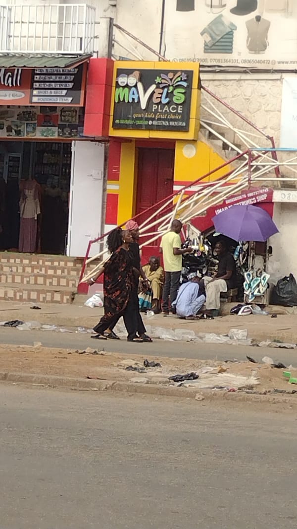 Daily life unfolds on Jos, Nigeria streets during afternoon hours