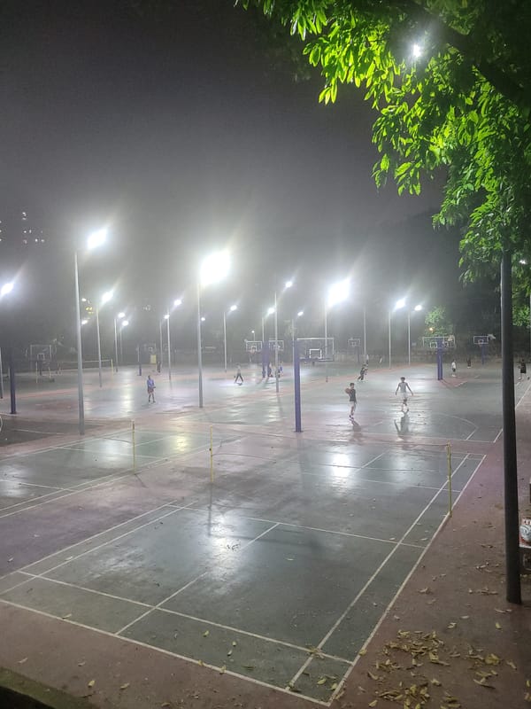 Nighttime street life and basketball activity in Shapingba District