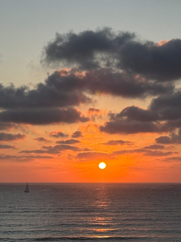 Sailboat on calm Mediterranean waters at Herzliya sunset