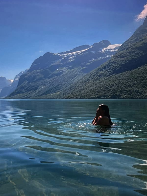 Kayaking on mountain-backed open water on a clear day