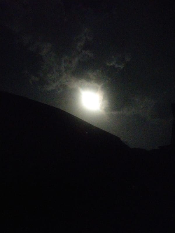 Witnesses observe flickering moonlight through clouds on May evening