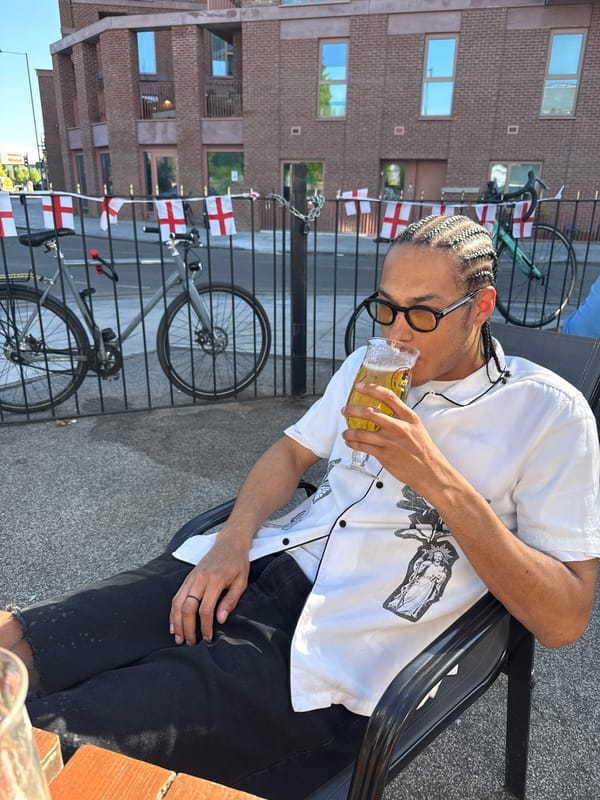 Person enjoys yellow drink outdoors in London