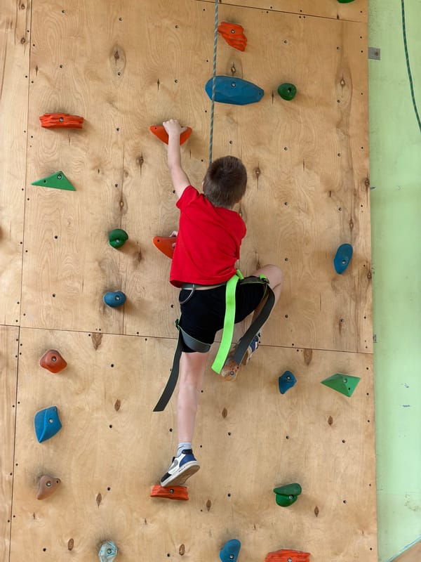 Boy rock climbs at indoor facility in Izhevsk