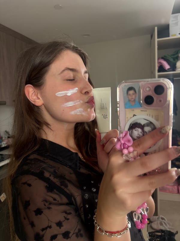 Woman documents skincare routine in selfie session in Getafe