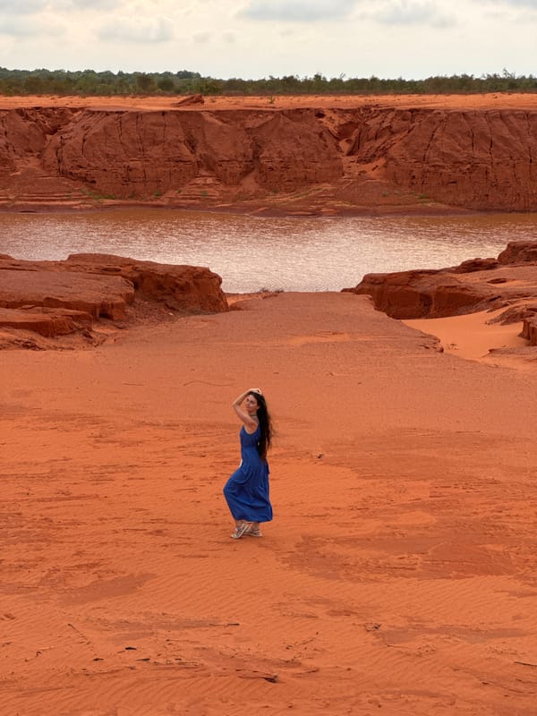 Woman in blue dress visits Mui Ne Red Sand Dunes