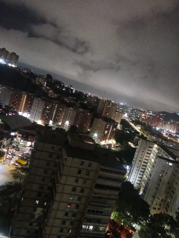 Nighttime Caracas captured from rooftops to living rooms