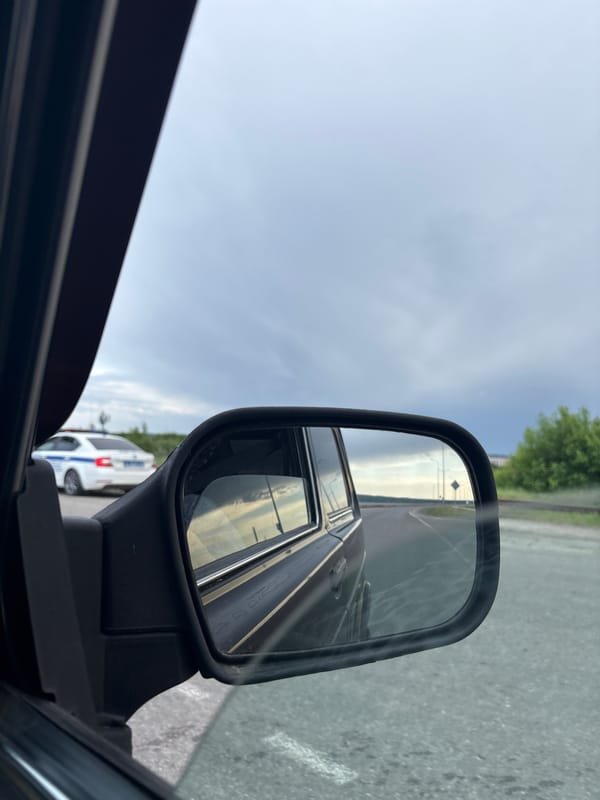 Storm clouds gather over Chaikovsky as vehicles navigate city