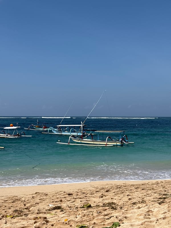 Beach day with traditional boats and beer toasts in Kuta Selatan