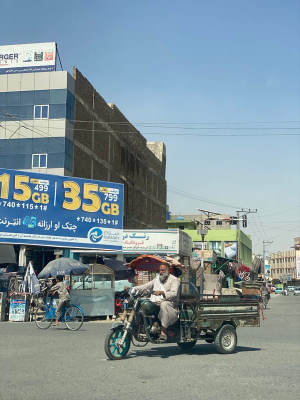 Three-wheeled transport on a busy Kandahar street