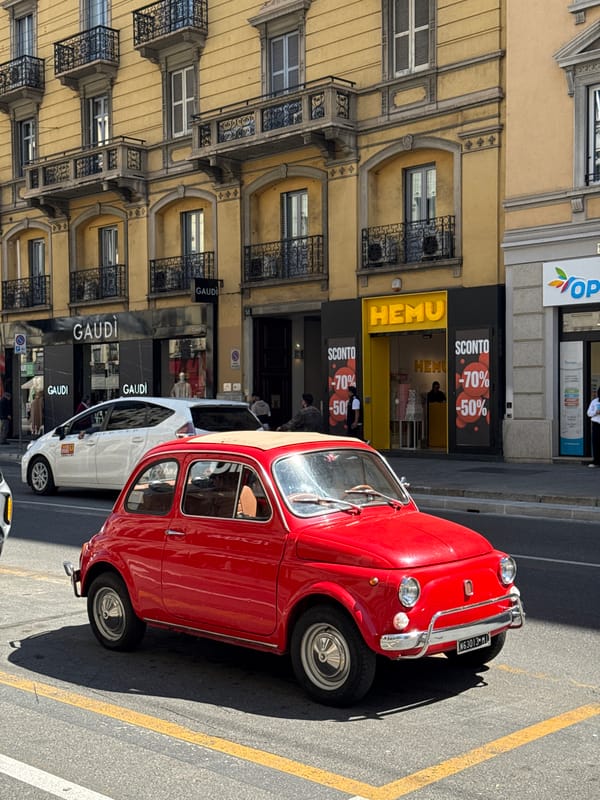 Red vintage Fiat 500 spotted parked on Milan street
