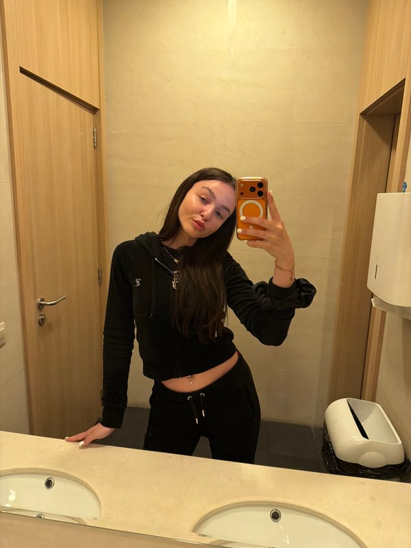Woman Takes Mirror Selfie in Sofia Public Restroom