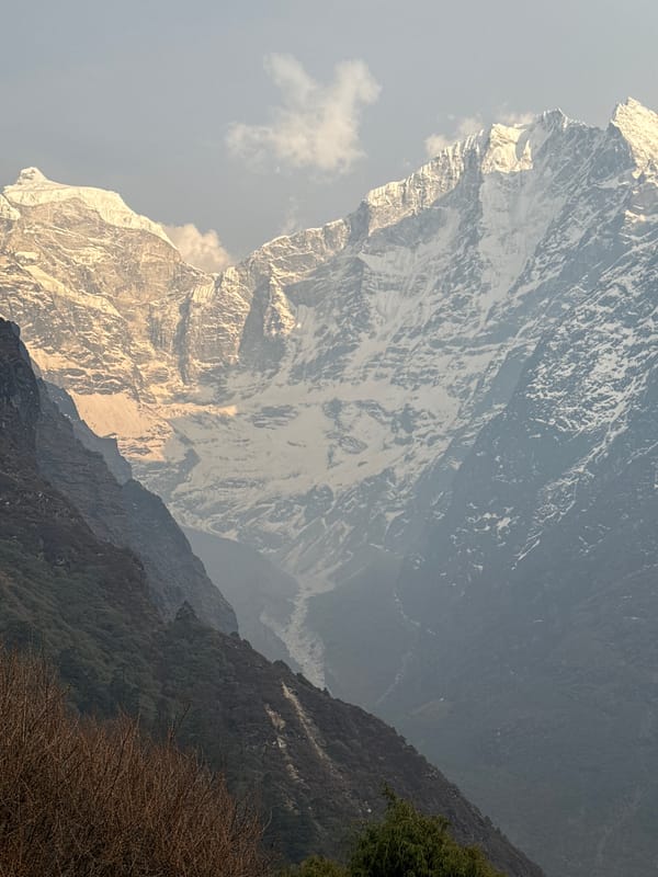 Tourist enjoys drink amid Himalayan peaks near Tengboche
