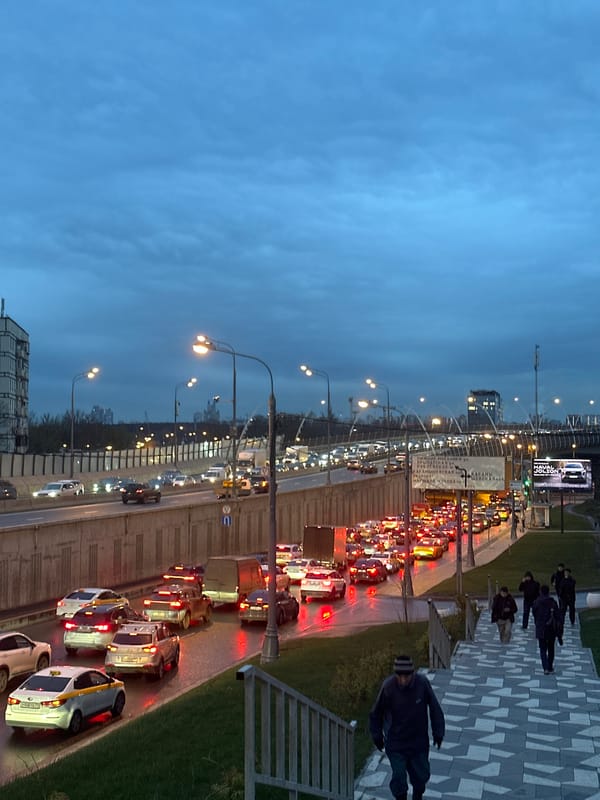 Evening traffic flows through wet Moscow streets