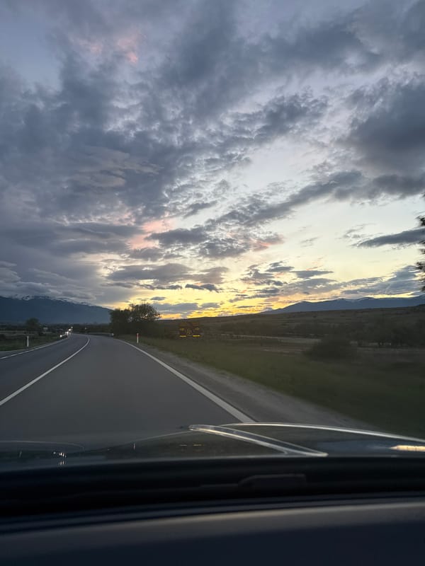 Driver travels mountain roads at dusk in Volkswagen