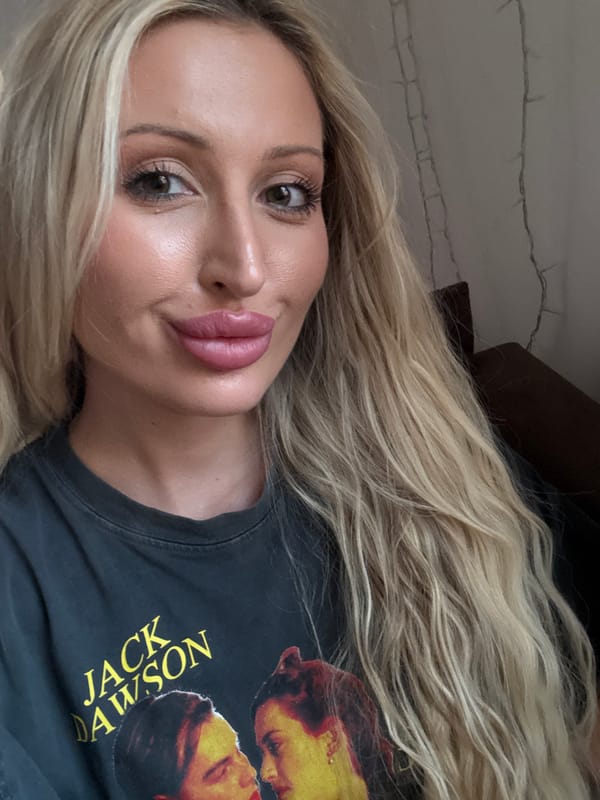 Close-up selfie in dim light, 'Jack Dawson' tee front and center