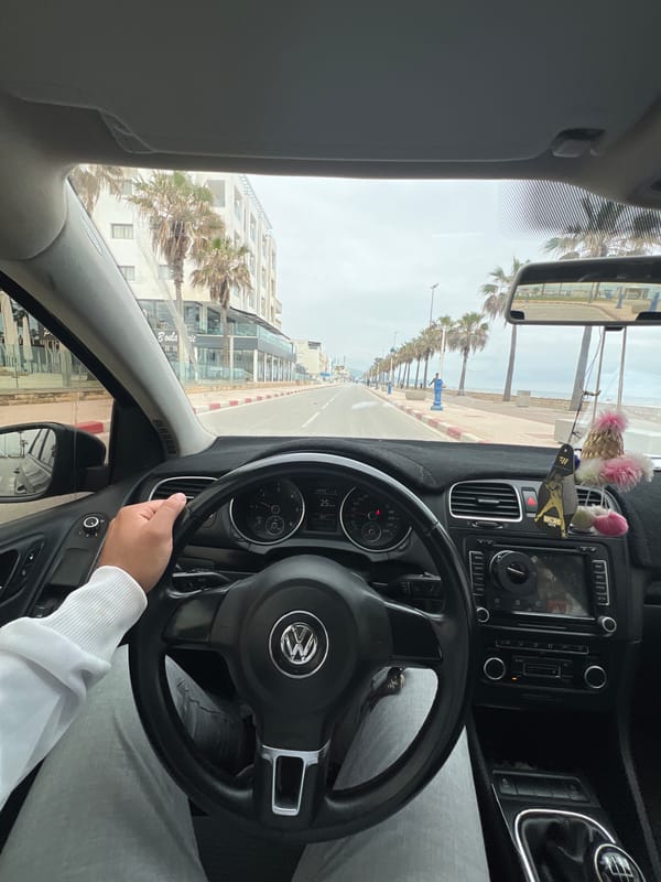 Driver travels coastal road in Martil, Morocco