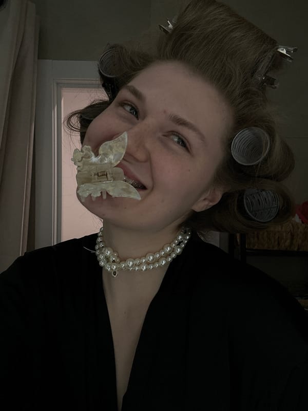 Woman in hair rollers and pearls photographed indoors in Kazan