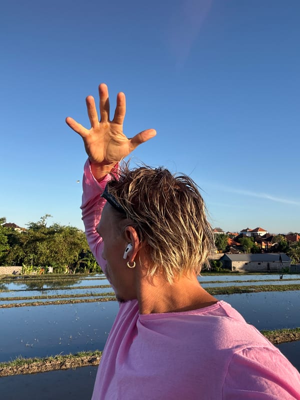 Person films content near rice paddies in Mengwi, Indonesia