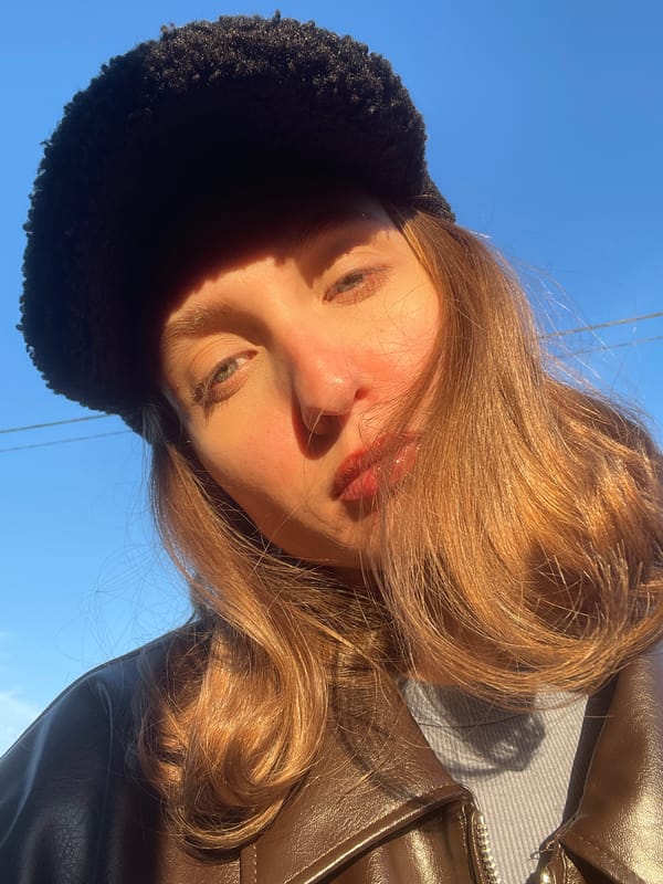 Young woman takes selfies in bright sunlight in Podshivalovo