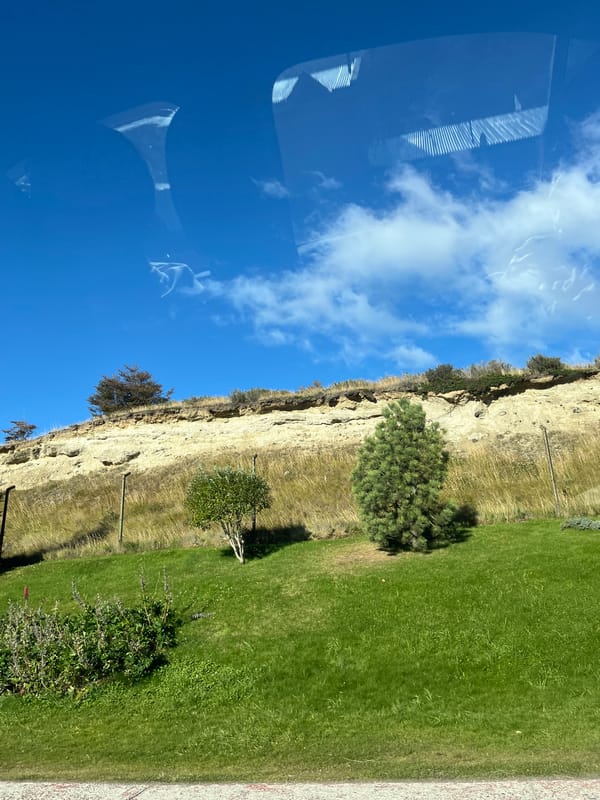 Vehicle passenger captures scenic cliff view near Ushuaia