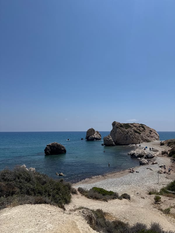 Tourists climb iconic Aphrodite's Rock in Cyprus under clear skies
