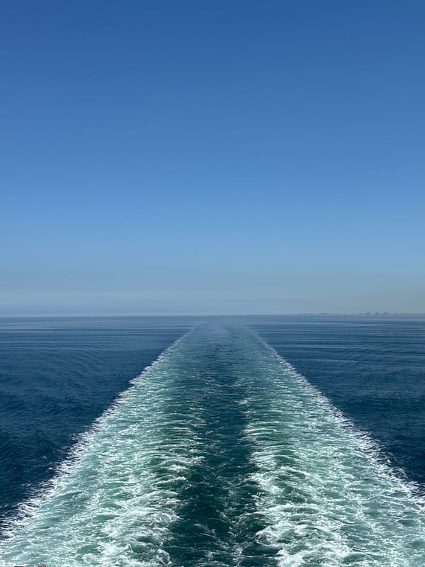 Ship creates wake in clear waters off French coast