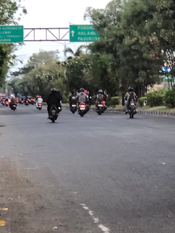 Heavy motorcycle traffic moves through Gelam's main road