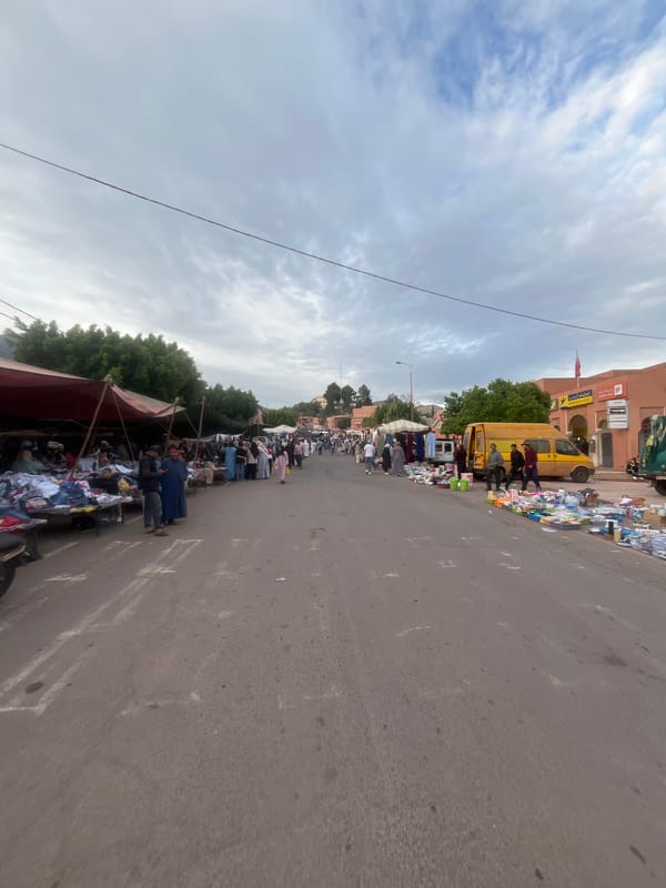Street market operates in Ouaouizert, Morocco selling pottery and produce