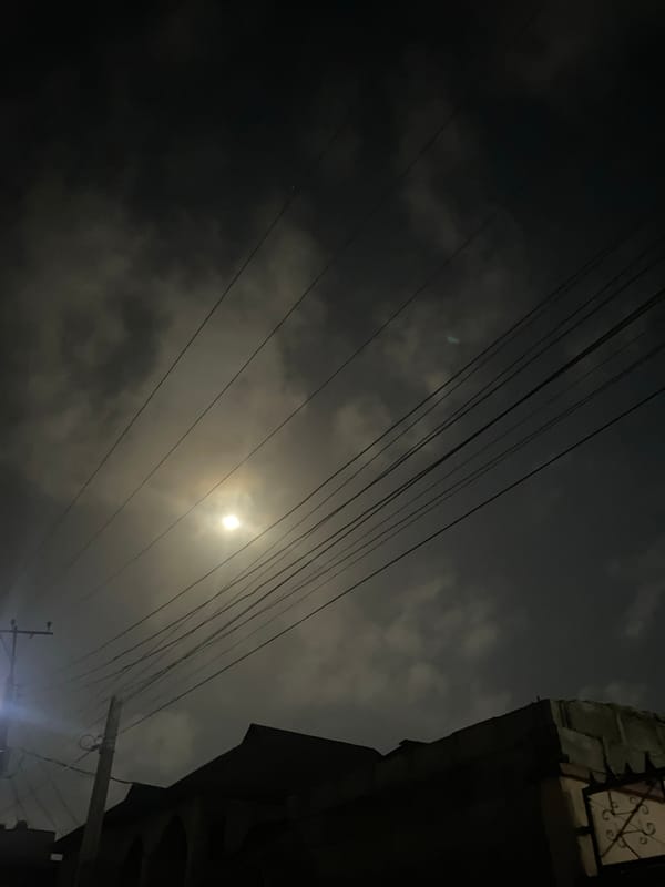 Night scene captured in Lagos showing moonlight through cloudy sky
