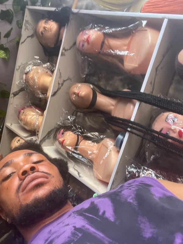 Man takes selfies in Nigerian wig shop
