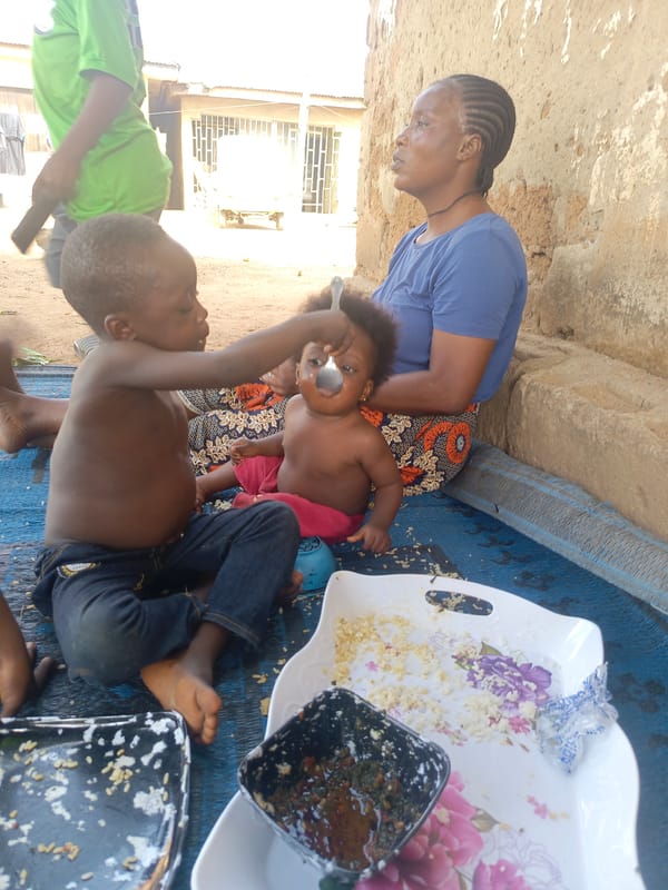 Butcher works at outdoor meat market in Akwanga, Nigeria
