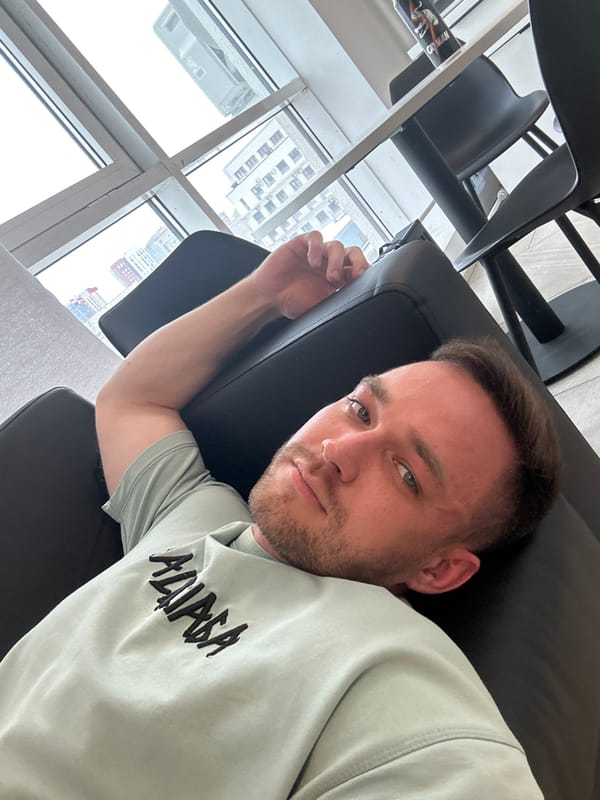 Man photographed in leather chair wearing Balenciaga sweatshirt, Perm
